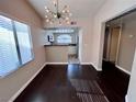 Dining room with hardwood floors, and decorative light fixture at 8455 W Sahara Ave # 213, Las Vegas, NV 89117