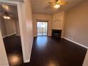 Living room with hardwood floors, fireplace, and access to the balcony at 8455 W Sahara Ave # 213, Las Vegas, NV 89117