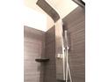 Modern shower with a rain head fixture and stone-look tile at 8455 W Sahara Ave # 213, Las Vegas, NV 89117