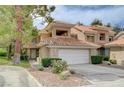 Inviting home with a two-car garage, beautiful landscaping, and well-maintained lawn at 8591 Heather Downs Dr, Las Vegas, NV 89113