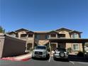 Full exterior view of the apartments featuring covered parking, and neutral earth tone exterior at 8805 Jeffreys St # 1103, Las Vegas, NV 89123