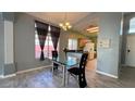 Open dining room with a glass table, stylish chairs, and natural lighting at 988 Upper Meadows Pl, Henderson, NV 89052