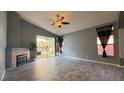 Bright living room with tile flooring, fireplace, and sliding glass doors leading to backyard at 988 Upper Meadows Pl, Henderson, NV 89052