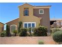 Charming two-story home featuring a blend of tan and brown siding with a private balcony at 1 Cerchio Basso, Henderson, NV 89011