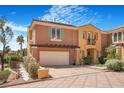 Charming townhome featuring stucco siding, an attached two-car garage, and well-manicured landscaping at 1 Cerchio Basso, Henderson, NV 89011