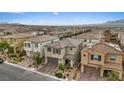 Expansive aerial view of a neighborhood showcasing multiple homes with well-maintained landscaping at 10324 Stroma Ave, Las Vegas, NV 89166