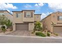 Two-story home featuring a brick driveway, desert landscaping, and neutral-toned exterior at 10324 Stroma Ave, Las Vegas, NV 89166