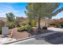 Attractive one-story home showcasing desert landscaping and a well-maintained yard at 10805 Hollow Creek Ln, Las Vegas, NV 89144
