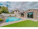 The refreshing backyard pool is surrounded by a stone patio, great for entertaining at 11477 Timber Mountain Ave, Las Vegas, NV 89135