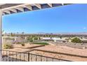 Enjoy panoramic city views from the backyard, featuring desert landscaping and iron railing at 1157 Morning Sun Way, Las Vegas, NV 89110