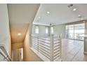 Open concept living area with modern railings, lots of windows, and neutral paint at 1275 Ice Park St # 101, Las Vegas, NV 89135