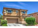 Charming two-story home featuring a tiled roof, a two-car garage, and desert landscaping at 1420 Gilbert Creek Ave, North Las Vegas, NV 89031