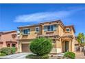 Home featuring a two-car garage, desert landscaping, shuttered windows, and an arched front door entrance at 1420 Gilbert Creek Ave, North Las Vegas, NV 89031