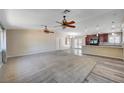 Spacious living room features neutral paint, ceiling fans, and new flooring at 1560 Arabian Dr, Henderson, NV 89002