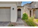Close up of front door with a paved walkway and desert landscaping at 1637 Harvest Pecan Ct, Las Vegas, NV 89108