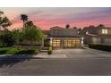 Beautiful two-story home at sunset with well-maintained landscaping, a three-car garage, and a spacious driveway at 188 Carthage St, Henderson, NV 89074