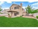 A spacious backyard with a covered patio, lush lawn, and ample room for outdoor activities at 2257 Norway Pine Ct, Las Vegas, NV 89134