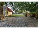 Large backyard featuring rock ground cover, a lush lawn and shade trees at 2926 E Eldorado Ln, Las Vegas, NV 89120