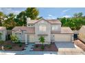 Charming two-story home with a well-maintained lawn, mature trees, and a convenient two-car garage at 3005 Treasure Island Rd, Las Vegas, NV 89128