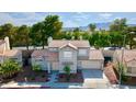 Charming two-story home with a well-maintained lawn, mature trees, and a convenient two-car garage at 3005 Treasure Island Rd, Las Vegas, NV 89128