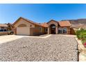 Inviting single-story home with arched entry and xeriscaped front yard at 307 Oak Canyon Dr, Henderson, NV 89015