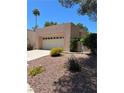 Inviting single-story home featuring a two-car garage, desert landscaping, and mature trees at 3394 Brookfield Dr, Las Vegas, NV 89120