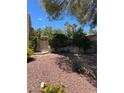 Mature trees and desert landscaping, including colorful flowers, add to the curb appeal at 3394 Brookfield Dr, Las Vegas, NV 89120