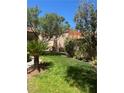 A lush green side yard, full of trees, offers a private outdoor space at 3394 Brookfield Dr, Las Vegas, NV 89120