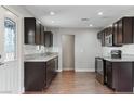 Updated kitchen featuring dark cabinets, granite countertops, and stainless steel appliances at 3412 Tabor Ave, North Las Vegas, NV 89030