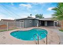 View of the pool with a fenced-in yard and covered patio area, ideal for outdoor entertaining at 3412 Tabor Ave, North Las Vegas, NV 89030