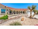 Beautiful single Gathering home with desert landscaping, a red tile roof and charming arched porch at 3640 E Vineyard Dr, Pahrump, NV 89048