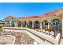 Beautiful home featuring desert landscaping, a red tile roof and charming arched porch at 3640 E Vineyard Dr, Pahrump, NV 89048