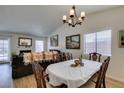 Light-filled dining room with wood floors flows into a living room with fireplace at 368 Umbria Way, Henderson, NV 89014