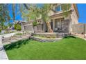 Home featuring a landscaped front yard with an inviting entryway with lush plants and comfortable seating at 3728 Richard Allen Ct, Las Vegas, NV 89147