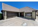 Tudor-style home features a two-car garage and front entrance in driveway at 3928 Edgemoor Way, Las Vegas, NV 89121