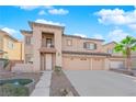 Two-story home featuring a three-car garage, balcony, neutral tones, and landscaped front yard at 4063 Lower Saxon Ave, North Las Vegas, NV 89085