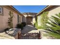 Inviting entryway showcasing a landscaped walkway leading to a double-door entrance with beautiful desert landscaping at 4299 Fiore Bella Blvd, Las Vegas, NV 89135