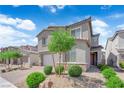 Inviting two-story home featuring a brick driveway, two-car garage, and attractive landscaping at 4428 Mural Glen Ct, North Las Vegas, NV 89084