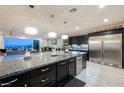 Open kitchen features granite countertops, stainless steel appliances, and pendant lighting, with an adjacent living area at 4576 Amazing View St, Las Vegas, NV 89129