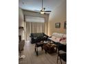 Bright living room with vaulted ceilings, tiled floors, ceiling fan, and fireplace, providing a spacious and airy atmosphere at 5161 Briar Meadow Way, Las Vegas, NV 89118