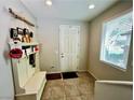 Bright entryway with tiled floors, coat rack, and natural light streaming through the window, creating a welcoming entrance at 5941 Galway Bay St, North Las Vegas, NV 89081