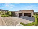 Long driveway leading to a modern home with spacious three-car garage at 641 Majestic Rim Dr, Henderson, NV 89012