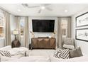 Cozy living room with neutral tones, stylish furniture, decorative pillows, and large television at 711 Florence Isle Ave, Henderson, NV 89015