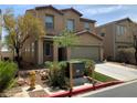 Two-story home with a two-car garage, neutral stucco, and easy access to utilities at 7788 Soda Canyon St, Las Vegas, NV 89139