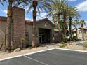 Clubhouse exterior featuring stone accents, manicured landscaping, and ample parking at 8000 Badura Ave # 1168, Las Vegas, NV 89113