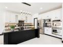 Modern kitchen featuring white cabinets, stainless steel appliances, and a granite island at 8244 Cupertino Heights Way, Las Vegas, NV 89178