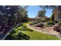 Lush backyard showcasing green synthetic grass, mature landscaping, and a well-maintained garden at 9180 Mohawk St, Las Vegas, NV 89139