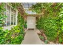 Charming entrance with lush greenery creating a welcoming and private approach to the front door at 9180 Mohawk St, Las Vegas, NV 89139