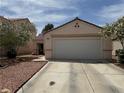 Inviting single-story home featuring desert landscaping, a two-car garage, and a concrete driveway at 9611 Sky Hollow Dr, Las Vegas, NV 89123