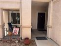 Inviting front porch with seating area and decorative accents, leading to the main entrance of the home at 9611 Sky Hollow Dr, Las Vegas, NV 89123